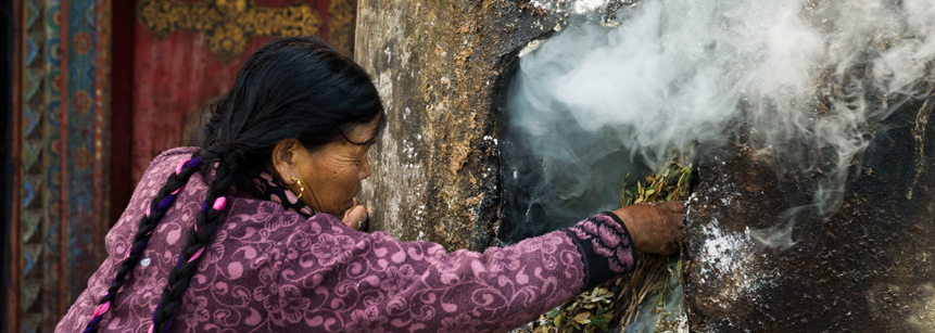 Tibetische Pilgerin mit Rauchwerk am Jokhang Tempel in Lhasa auf einer Tibet Reise