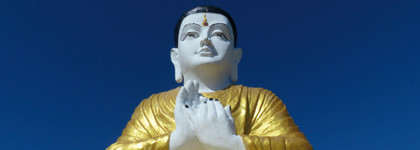 Buddhafigur in Myanmar vor blauem Himmel